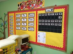 a bulletin board in a classroom with mickey mouse writing on it and other decorations around the perimeter