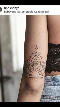 a woman's arm with a lotus tattoo on the left side of her body