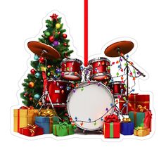 a christmas tree with presents around it and a drum set in front of the drums