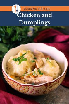 a bowl filled with chicken and dumplings on top of a table