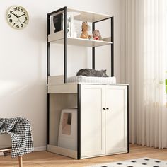 a cat laying on top of a book shelf next to a chair and clock in a living room