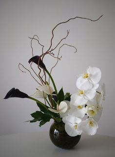 a vase filled with white flowers on top of a table