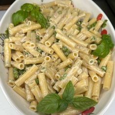 a white bowl filled with pasta and vegetables