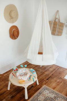 a baby's play table in the corner of a room with a teepee tent