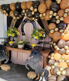 a table with balloons and decorations on it