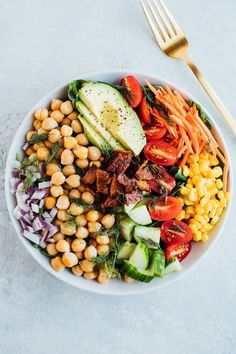 a white bowl filled with vegetables and meat