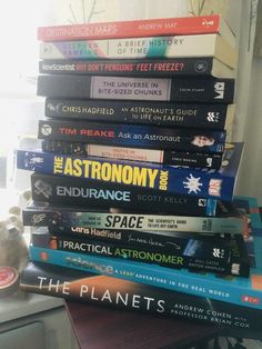 a stack of books sitting on top of a table