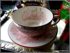 two cups and saucers sitting on top of each other next to some candy bar wrappers