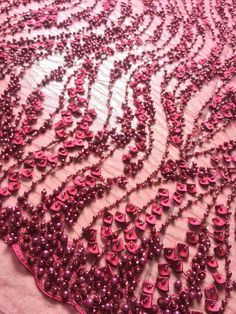 pink beaded lace with beads on it