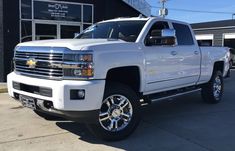 a white truck parked in front of a building