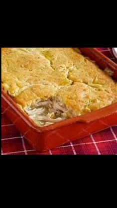 a casserole dish with meat and vegetables in it on a red checkered table cloth