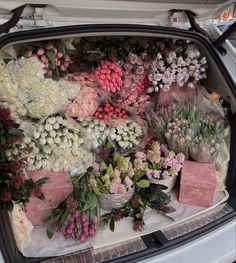 the trunk of a car filled with flowers