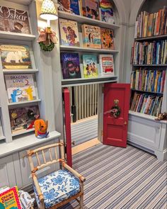 the children's room is decorated in blue and white with bookshelves on either side