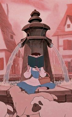 a woman sitting on the ground reading a book in front of a fountain with two dogs