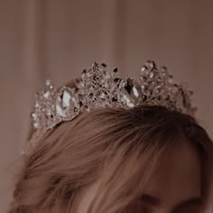 a close up of a woman wearing a tiara