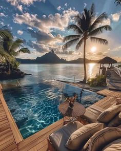 an outdoor swimming pool with lounge chairs and palm trees in the background at sunset or sunrise