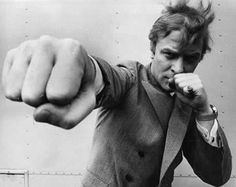 a black and white photo of a man pointing his finger