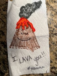 a hand towel with an image of a volcano on it that says i lava you