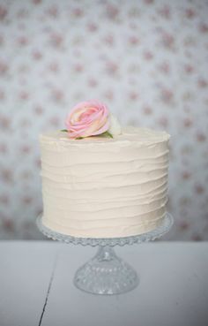 there is a white cake with pink flowers on it and the words candy buffet inspiration