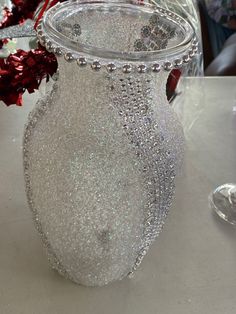 a glass vase sitting on top of a table