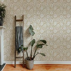 a living room with a fire place and potted plants