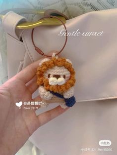 a crocheted keychain with a lion on it's face is shown