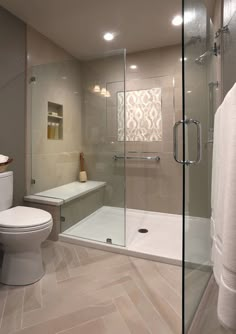 a bathroom with a glass shower door and toilet