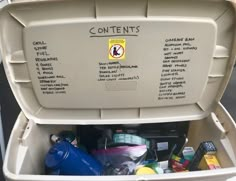 a white container filled with lots of different types of items and labeled contents in it