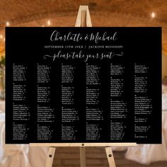 a black and white wedding seating chart on an easel