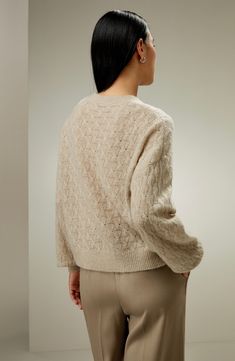 This sweater has a twisted pattern all over and the special yarn gives it a plush feel. Match it with an elegant long skirt for a delicate overall look, or select wide-legged trousers for a more casual look. It's perfect as an outerwear piece for early autumn. 75% cashmere+25% silk round neck oversize wearable from fall to winter Elegant Beige Soft Knit Cardigan, Elegant Cable Knit Sweater For Spring, Elegant Cream Sweater For Fall, Elegant Long Sleeve Cardigan With Soft Texture, Chic Cashmere Sweater With Pointelle Knit, Elegant Fall Sweater With Soft Texture, Elegant Sweater With Soft Texture For Layering, Beige Mohair Sweater, Elegant Cream Cardigan With Crew Neck