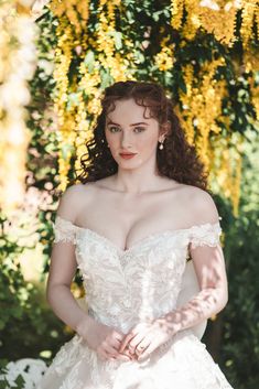 a woman in a wedding dress posing for the camera