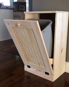 a wooden cabinet with an open door on the floor