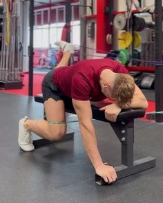 a man doing squats on a bench in a gym