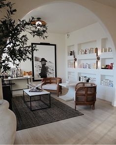 a living room filled with furniture and a tree