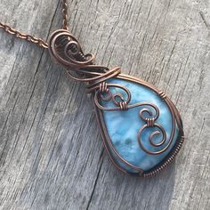 This is a gorgeous ocean blue natural Larimar pendant necklace. It has been hand wrapped using pure copper wire which has been antiqued and polished to achieve a gorgeous rustic look with a unique design.  This pendant measures about 2 inches tall from the bottom of the pendant to the top of the bail. Pendant comes with a complimentary antique red copper plated chain of your choice. Chain is removable and interchangeable.  Due to this cabochon pendant being entirely hand wrapped with detail and Blue Copper Wire Wrapped Necklaces, Blue Copper Wire Pendant Necklace, Blue Pendant Necklace With Copper Wire, Blue Copper Wire Wrapped Necklace, Spiritual Blue Hand Forged Necklace, Hand Wrapped Blue Copper Necklaces, Blue Copper Necklace Hand Wrapped, Blue Copper Necklaces Hand Wrapped, Larimar Properties