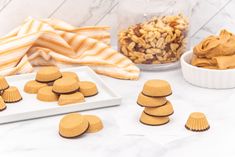 some cookies are arranged on a table with other treats