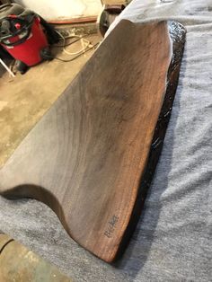 a wooden surfboard sitting on top of a table