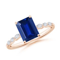 a blue sapphire and diamond ring on a white background