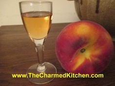 an apple sitting next to a glass of wine