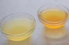 three bowls filled with orange juice on top of a table