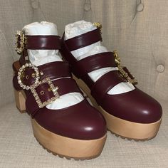 New!! Never Worn Authentic Autumn Adeigbo Clogs - Currently At Nordstrom For $780. Featuring A Trio Of Straps Detailed With Signature Mixed-Match Crystal Buckles, These Wooden Clogs Are Crafted Of Burgundy Red Leather. The Closed-Toe Style Sits On A 1.75" Platform That Makes The 4" Heel Comfortably Walkable. They're Finished With A Vibram Rubber Sole For Great Traction And Shock-Absorbing Support. * Produced In Limited Quantities. * 4" Wood Heel. 1.75" Wood Platform. (Size Eu 40/ Us 9) * Leather Party Platform Clogs With Round Toe, Party Platform Clogs With Closed Toe, Leather Clogs With Red Sole And Round Toe, Leather Clogs With Round Toe For Party, Leather Round Toe Clogs For Party, Party Leather Clogs With Round Toe, Leather Party Clogs With Round Toe, Party Clogs With Wooden Block Heel, Autumn Adeigbo