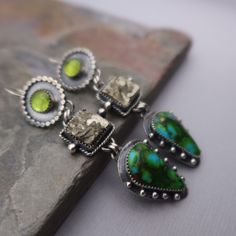 Beautiful blue/green turquoise, pyrite and peridot set in sterling silver.  These earrings measure 3 inches long and 5/8 inches wide at the widest point.  All components are sterling silver and have been oxidized and polished. Each earring weighs:  11.9 grams Thanks for shopping! Lapidary Jewelry, Jewelry 2024, Jewelry Closet, Art Jewelry Earrings, Blue Green Turquoise, Metalsmithing Jewelry, Bold Jewelry, Dope Jewelry, Silver Dangle Earrings