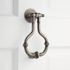 an image of a door handle on a white door that is painted in antique silver