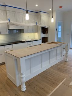 a kitchen with white cabinets and an island in the middle is being remodeled to look like it has been renovated