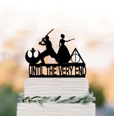 a wedding cake topper with the silhouette of a man and woman riding a horse