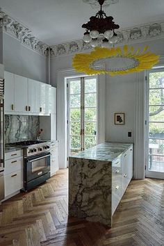 a kitchen with marble counter tops and an island in front of a stove top oven