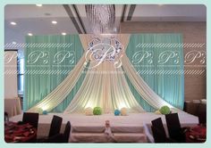 an image of a banquet room setting with drapes and table cloths set up