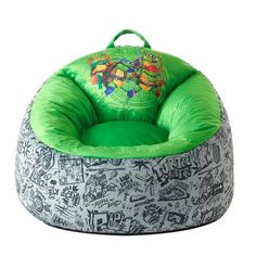 a green and gray bean bag chair with teenage mutant designs on the front, sitting up against a white background