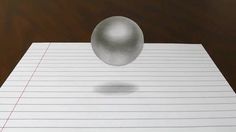 an image of a ball on top of a piece of paper that is lined with lines