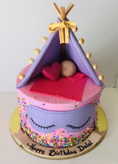 a birthday cake that is shaped like a tent